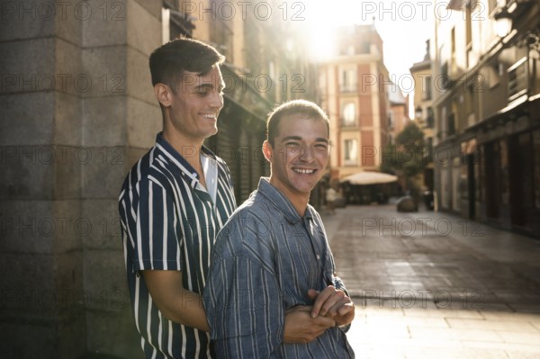 A joyful gay couple embraces while strolling down the sunlit streets of Madrid. Capturing love, camaraderie, and the essence of LGBTQIA+ pride in an urban setting