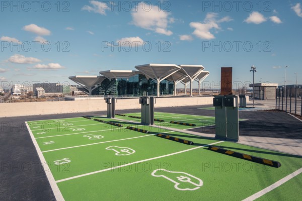 View of a new transport hub in Valdebebas, Madrid, featuring parking with electric vehicle charging stations