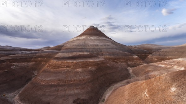 Captivating view of the Hanksville Bentonite hills in Utah, USA. The vibrant layered formations showcase natural beauty and geological wonders under a vast sky