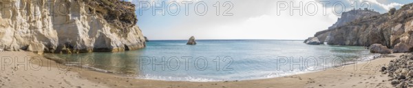 Panoramic image of the secluded beach Gerontas on the Island of Milos in Greece, showcasing tranquil turquoise waters bordered by white cliffs and a pristine sandy beach