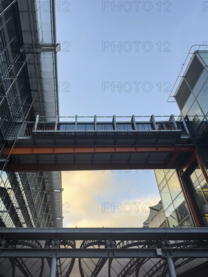 A dynamic view of London Heathrow airport architecture showcasing metal and glass structures. The sky serves as a calming contrast, highlighting urban design in a bustling cityscape