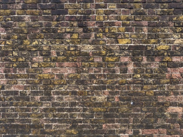 Detailed view of a vintage brick wall in London, showcasing a mix of weathered red and yellow bricks. The texture captures the rustic charm and historical essence of urban architecture