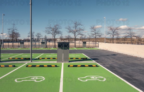 A newly constructed electric vehicle charging station in Valdebebas, Madrid, showcasing green ecological transport solutions near the city's transport hub, including metro, underground, suburban trains, and buses