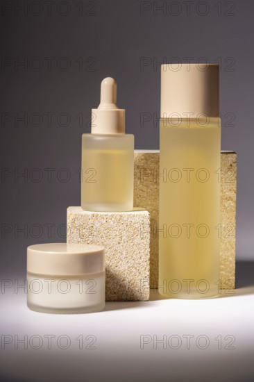 A stylish arrangement of cosmetic bottles in different sizes, showcased on textured stone podiums, emphasizing modern beauty and skincare aesthetics