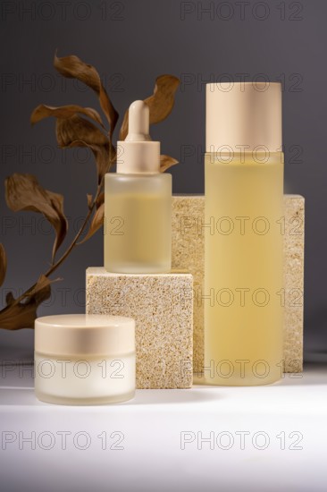 A collection of elegant skincare bottles and jars gracefully arranged on textured stone pedestals, complemented by a background of dried leaves, showcasing natural beauty elements and modern cosmetic packaging