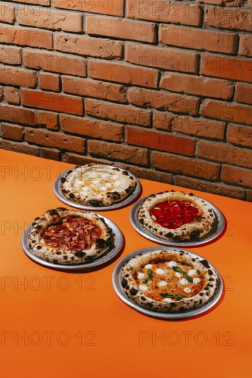 A mouthwatering assortment of pizzas featuring Margherita, Pepperoni, Four Meats, and Four Cheese. Each pizza showcases a unique blend of fresh ingredients and flavors