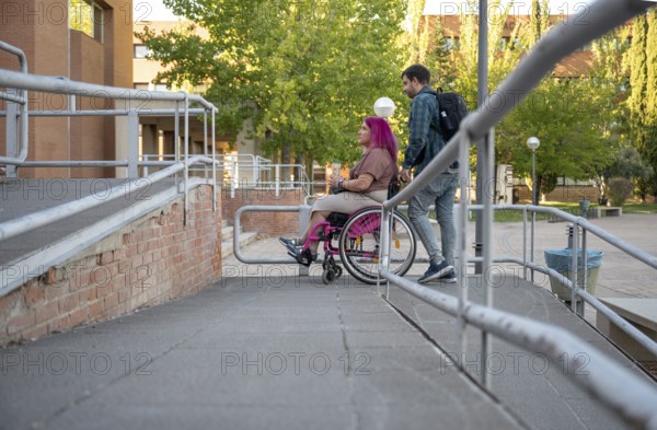 A couple navigating their college campus, with the woman using a wheelchair due to spina bifida They exemplify accessibility and inclusivity in educational environments