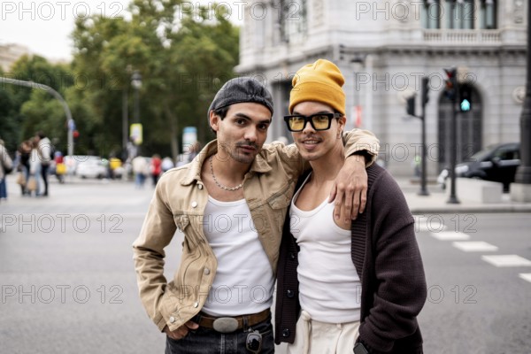 A Colombian gay couple stands joyfully in an urban setting. They wear casual outfits, expressing a sense of love and connection, with stylish urban architecture in the background