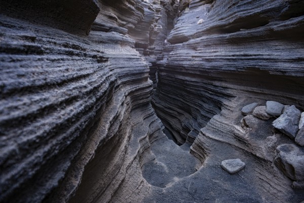 Intricate volcanic rock formations showcasing layered textures inside the popular natural cave in Lanzarote, Canary Islands