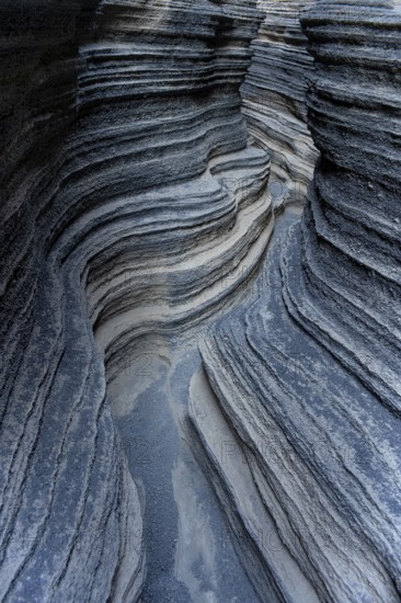 Detailed view of the textured and layered rock formation, showcasing the natural artistry of volcanic activity on Lanzarote Island