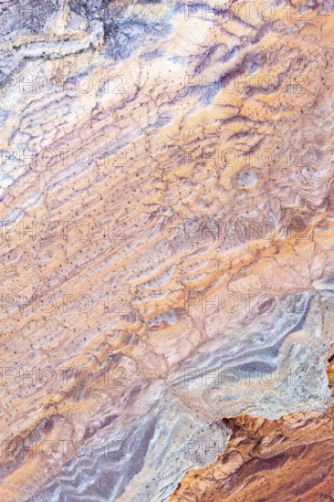 Aerial view of intricate, colorful textures at Vermilion Cliffs National Monument, Arizona, showcasing the natural beauty and geological formations of the desert landscape