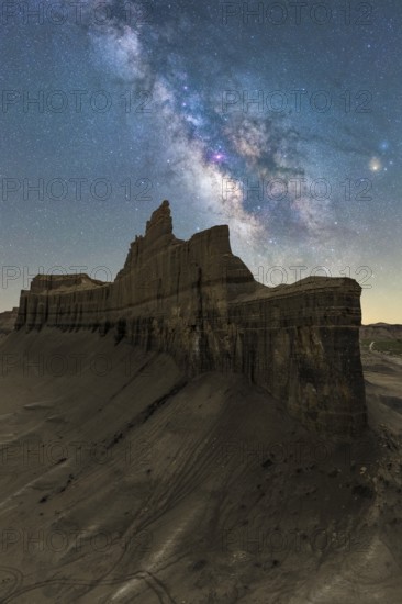 A mesmerizing night view capturing the Milky Way sprawling above the striking rock formations of Goblin Valley State Park in Utah, USA, set against a clear desert sky
