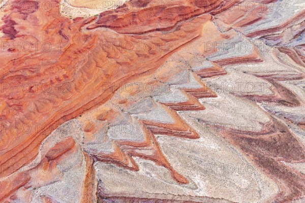 Striking aerial photograph showcases intricate, colorful rock formations surrounding the San Juan River in Utah, highlighting the unique geological textures and patterns of the area