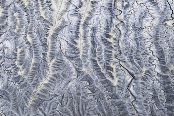 An aerial photograph showcasing the intricate, rugged textures of Moonscape Overlook, Utah, resembling the surface of the moon