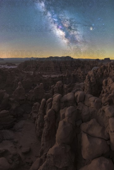 Captivating night sky illuminates the unique rock formations of Goblin Valley State Park in Utah, with the brilliant Milky Way galaxy arching above