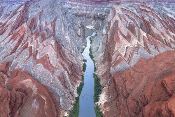 A captivating aerial shot of the winding Rio San Juan flowing through the vibrant red rock formations in Utah, USA, showcasing nature's artistic sculpting
