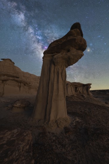 A breathtaking night view of sandstone formations under a starry sky in Goblin Valley State Park, Utah. The Milky Way adds an awe-inspiring touch to the rugged landscape