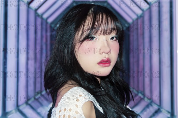 An Asian Gen Z girl with creative makeup explores a bright and vibrant arcade, embracing the lively atmosphere Her artistic style reflects youthful energy and modern trends