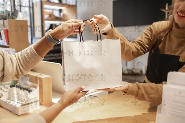 A customer receives a shopping bag from a worker at a cosmetics store. The hands exchange symbolizes customer service and retail experience within a vibrant shopping environment