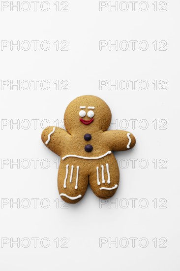 A charming gingerbread man cookie decorated with classic icing details on a white background Perfect for holiday themes, baking inspiration, or festive displays