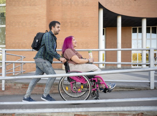 A couple at college exemplifies inclusion and accessibility The woman uses a wheelchair due to spina bifida, as they navigate campus life together