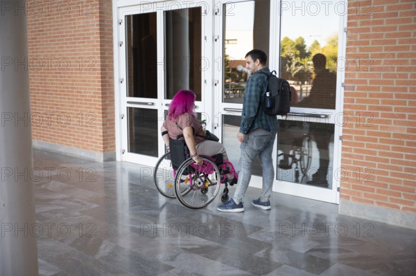 A college couple, with the woman using a wheelchair due to spina bifida, navigates campus They illustrate diversity, inclusion, and support in an academic setting