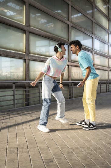 A happy couple shares a joyful moment outdoors, dressed in colorful, casual outfits. Smiling and engaging playfully, they enjoy a carefree day in the sun