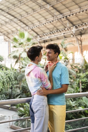 A cheerful gay couple embracing in a lush indoor garden. Their colorful outfits and vibrant surroundings highlight a joyful celebration of love and togetherness