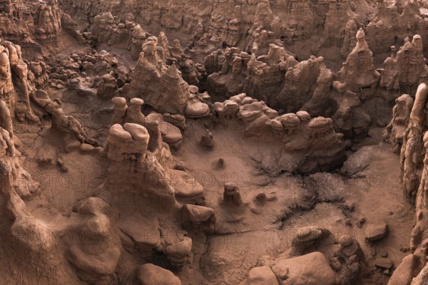 Aerial view of the bizarre and unique rock formations known as hoodoos in Goblin Valley State Park, Utah, displaying a captivating landscape of natural red rock artistry