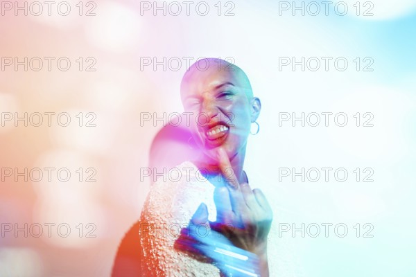A bold woman expressing defiance with her middle finger towards camera, surrounded by vibrant, colorful abstract lighting