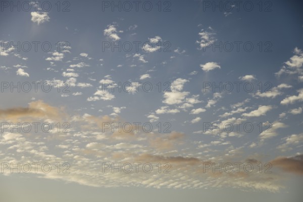 Soft scattered clouds in the sky during dusk. The pastel colors create a dreamy and tranquil atmosphere