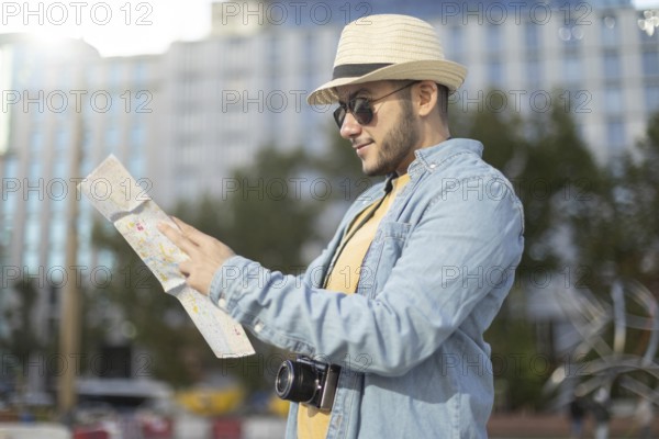 A Latino transgender man in a hat and sunglasses explores a city with a map and camera, embracing adventure and diversity Proud representation of the LGBTQIA+ community