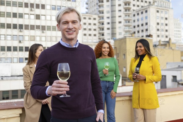 A group of friends gathers on a rooftop, enjoying a joyous celebration with drinks in hand, set against a cityscape Their cheerful expressions highlight the festive atmosphere