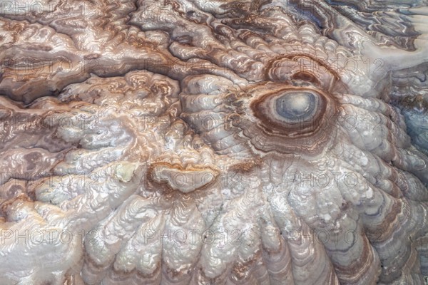 This aerial image captures the mesmerizing abstract patterns of bentonite sandstone in Utah, USA. The swirling textures and vivid colors showcase the region's unique geological beauty