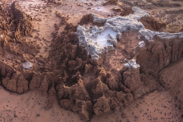 Aerial view of the unique, eroded rock formations in Goblin Valley State Park, Utah, showcasing the striking geological features and sandy landscape