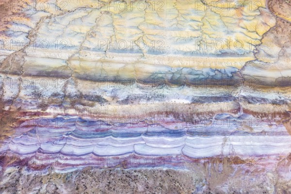 Explore the captivating textures of Vermilion Cliffs National Monument in Arizona. This aerial view reveals colorful desert layers, showcasing the area's natural geological artistry