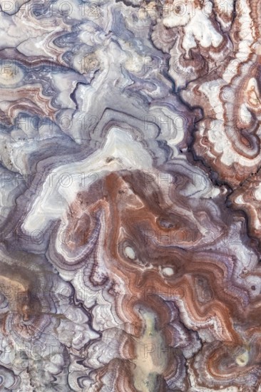 Stunning aerial view of Utah's bentonite sandstone formations. The vibrant layers create a mesmerizing, abstract geological pattern in a unique natural landscape