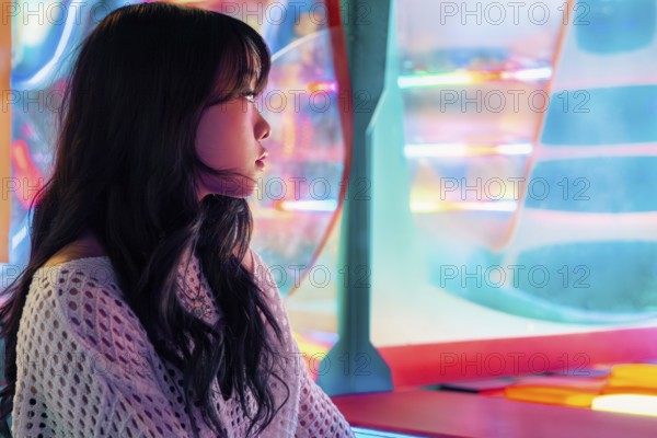 A young Asian Gen Z girl enjoys vivid lights and colors in an arcade, capturing the essence of modern youth and entertainment The scene is lively and dynamic
