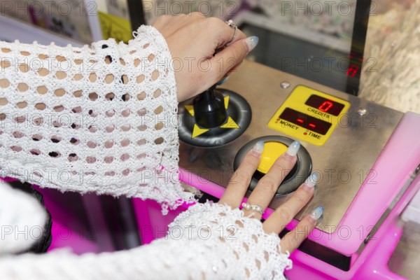 Gen Z girl enjoys her time at an arcade, using joystick controls for entertainment The vibrant setting captures the essence of playful youth and gaming enthusiasm