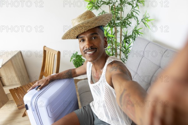 A cheerful LGBTQIA+ individual with a suitcase, ready for holiday adventures. Wearing a straw hat and mesh top, they exude excitement and holiday spirit
