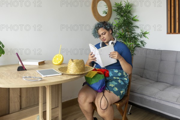 A transgender man, sitting comfortably in a modern styled room. He is deeply engaged in reading a book, with colorful everyday objects and natural elements surrounding him, enhancing the calm and relaxed atmosphere