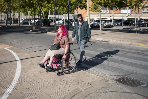 A couple navigates college life, highlighting inclusivity and diversity The woman, using a wheelchair due to spina bifida, symbolizes resilience and strength
