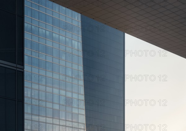 Close-up view of sleek, modern glass buildings in a downtown setting showcasing contemporary architecture. Ideal for themes of urban life, business, and modern commuting