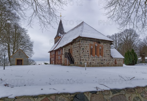 Lassahn village church in the snow in the Schaalsee UNESCO Biosphere Reserve. Lassahn, Mecklenburg-Western Pomerania, Germany
