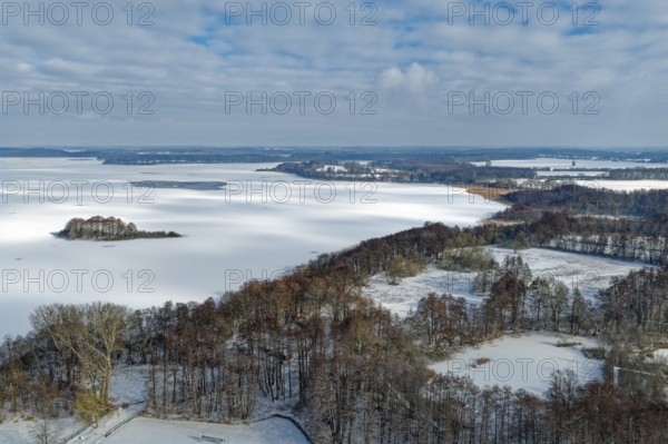There is snow on the frozen Schaalsee near Zarrentin in the UNESCO Schaalsee Biosphere Reserve. aerial view. Zarrrentin, Mecklenburg-Western Pomerania, Germany