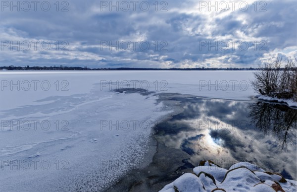 View of Schaalsee, covered with ice and snow, on the bridge tour, a hiking trail around Lake Kirchensee, in the UNESCO Schaalsee Biosphere Reserve. Zarrentin, Mecklenburg-Western Pomerania, Germany