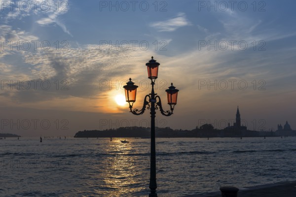 View of Giudecca Island in the evening, historic lantern in front, Venice, Veneto, Italy