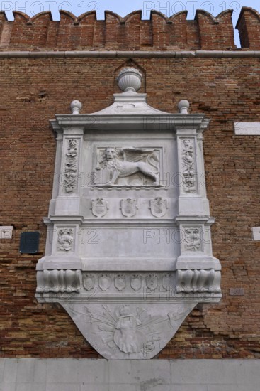 Heraldic relief of the city of Venice the Lion of St. Mark, on the wall of the Arsenal, weapons depot, Venice, Veneto, Italy