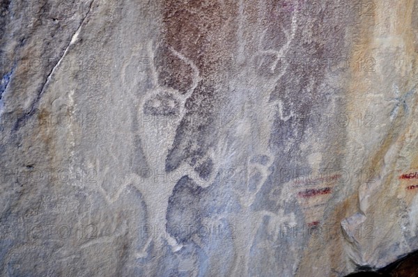 Prehistoric rock carvings, petroglyphs from the Fremont culture, of human-like figures on a rock, Dinosaur National Monument, Utah, USA