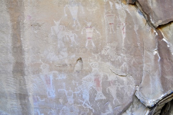 Ancient rock art, petroglyphs from the Fremont culture with human figures in shades of red and white, Dinosaur National Monument, Utah, USA